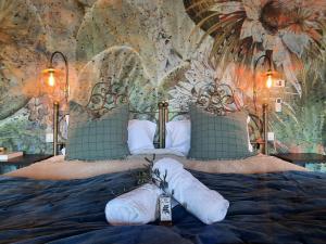 a bedroom with a large bed with towels on it at Gli sterpi in Sinalunga +21 photos