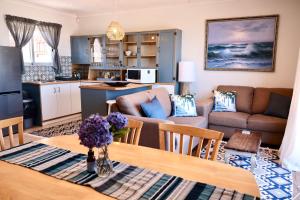 a kitchen and a living room with a table at Apartment Sapphire in Herolds Bay