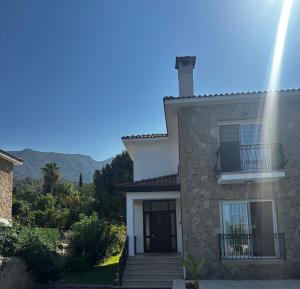 a house with a stairway leading to the front of it at Hillside Villa with Sea Views in Kyrenia