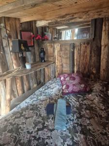 a bedroom with a bed in a wooden cabin at Cabane en Cévennes in Saint-Germain-de-Calberte