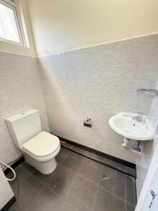 a bathroom with a toilet and a sink at Misty Hues in Kandy
