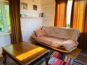 a living room with a couch and a table at Väikse haldja onn in Majala