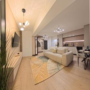 a living room with a couch and a table at LUAME Residence , langa Arena Mall, aproape de centru in Bacău