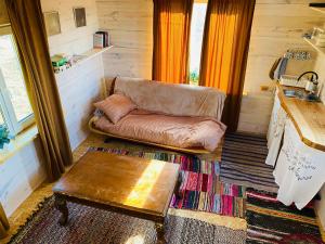 a living room with a couch and a table at Väikse haldja onn in Majala +7 photos