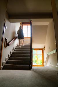 a woman walking up the stairs in a house at Tunqueley Hotel in San Martín de los Andes