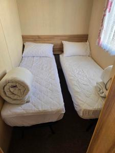 two twin beds in a small room with at Towyn Winkups F07 in Rowen