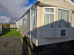 a small house is parked in a yard at Towyn Winkups F07 in Rowen