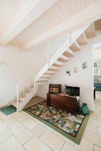 a living room with a staircase and a couch at Il Conventino 46 in Falconara Marittima +29 photos