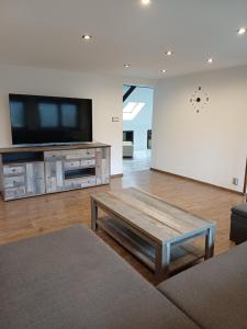 a living room with a flat screen tv and a coffee table at MARLEN in Ústí nad Labem