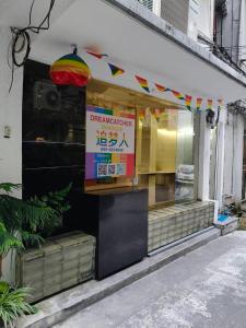 a restaurant with a sign in the window of a store at Dreamcatcher Bangkok in Bangkok