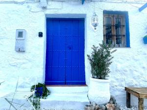 a blue door on the side of a white building at Las Parras in Rute +16 photos