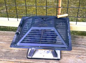 a grill sitting on top of a wooden table at Jennys creekside bliss in Otto