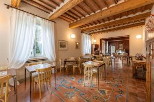 a restaurant with tables and chairs in a room at Nobilis Charme Relais in Montepulciano
