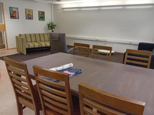 a conference room with a table and chairs at Hostel Yöpöllö in Kouvola