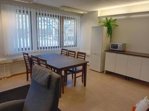 a kitchen and dining room with a table and chairs at Hostel Yöpöllö in Kouvola