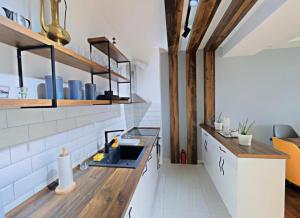 a kitchen with white walls and wooden beams at Ana VS Apartment in Ohrid
