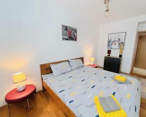 a bedroom with a bed and a red chair at Ana VS Apartment in Ohrid