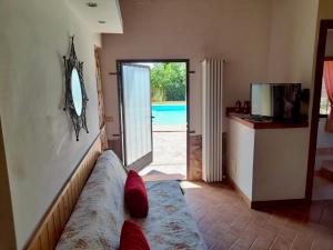 a living room with a couch and a mirror on the wall at Secret Haven in La Croce