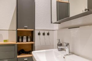 a bathroom with a sink and a mirror at Ferienwohnung Anna in Heimbach +8 photos