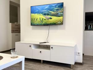 a living room with a tv on a wall at Fine Apartment in Jelgava