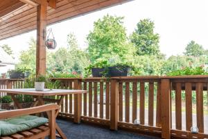 a wooden deck with a table and chairs on it at Ferienwohnung Anna in Heimbach