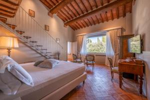 a bedroom with a bed and a staircase and a desk at Nobilis Charme Relais in Montepulciano +48 photos