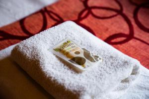 a packet of toothpaste sitting on a pile of towels at Tunqueley Hotel in San Martín de los Andes