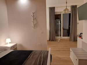 a bedroom with a bed and a living room at Antica Dimora Petito Luxury in Matera