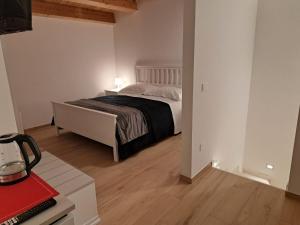 a bedroom with a bed in a room with a desk at Antica Dimora Petito Luxury in Matera