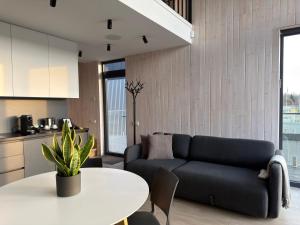 a living room with a couch and a table at WakeMālpils brīvdienu mājas in Mālpils