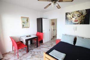 a room with a bed and a table and chairs at Apartments Aurelia in Vodice