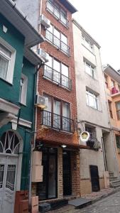 a brick building on a city street with two buildings at Balat Life Suites in Istanbul
