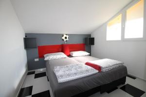 a bedroom with a bed with a soccer ball on the head at Apartments Aurelia in Vodice +38 photos