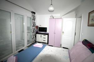 a bedroom with a bed and a tv in it at Apartments Aurelia in Vodice