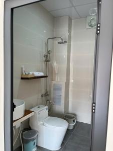 a bathroom with a shower and a toilet and a sink at Sola Hòn Sơn in Lai Sơn