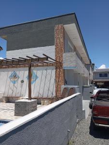 a house with two chairs on the front porch at imovel 2 e 3 in Guaratuba