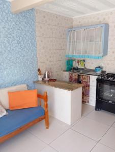 a kitchen with a counter and a stove at imovel 2 e 3 in Guaratuba