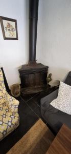 a living room with a wood stove in the corner at Casa Pura de Trevélez in Trevélez