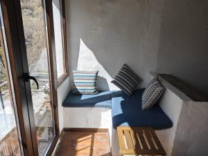 three pillows sitting on a wall next to a window at Casa Pura de Trevélez in Trevélez