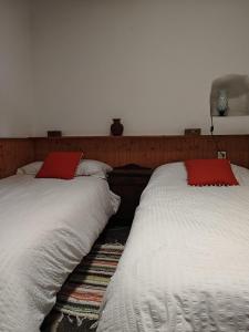 two beds sitting next to each other in a bedroom at Casa Pura de Trevélez in Trevélez +24 photos