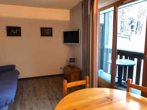a living room with a couch and a table and a window at Abondance appartement 4 pers in Abondance
