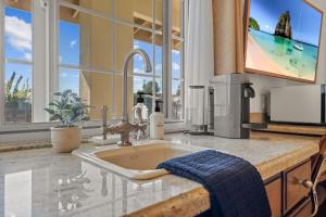 a kitchen with a sink with a blue towel at Bella Notte by the Beach in Santa Cruz