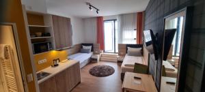 a small living room with a couch and a table at my MINGA Airport serviced Apartments in Hallbergmoos