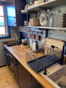 a kitchen counter with a dish drying rack next to a sink at Bregnehytte in Leikanger +23 photos
