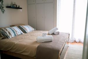 a bedroom with a bed with two towels on it at Blue Horizon Corinth in Korinthos
