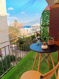 a balcony with a table and a view of the ocean at Blue Horizon Corinth in Korinthos