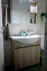 a bathroom with a white sink and a mirror at Blue Horizon Corinth in Korinthos +28 photos