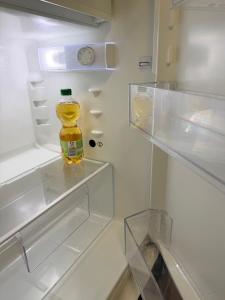 a bottle of orange juice sitting in an empty refrigerator at Sternlicht Rachida in Albstadt
