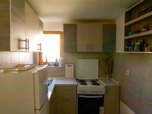 a small kitchen with a stove and a refrigerator at Villa Mia in Sarajevo