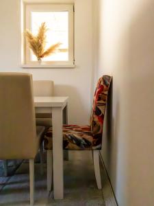 a chair sitting next to a table with a window at Villa Mia in Sarajevo